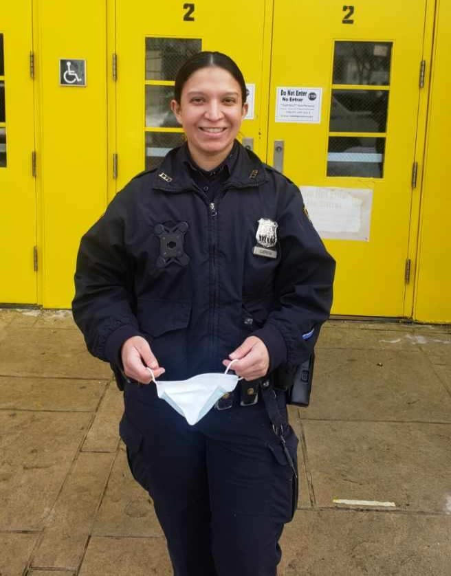 Police Officer Cabrera in front of the yellow doors of P.S. 28