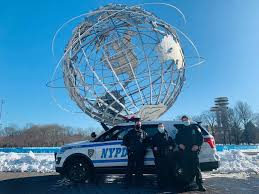 Corona Youth Coordination Officers with their patrol car by the Unisphere