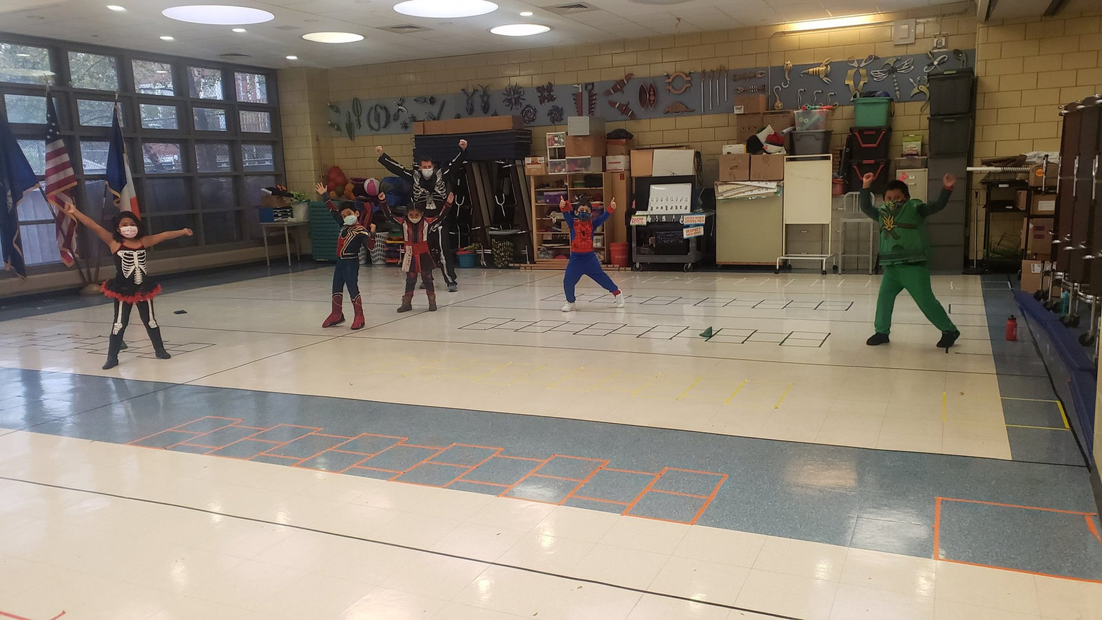 Students in Halloween costumes dancing in the gym