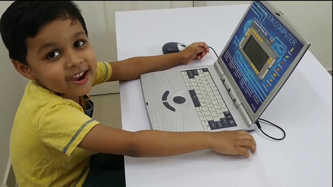 A smiling student working on a laptop