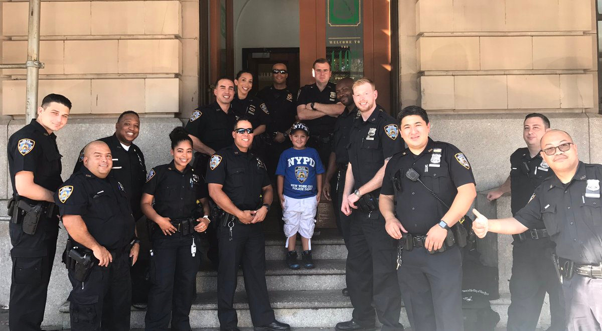 Officers from the 110 Precinct gathered on the front steps of the precinct