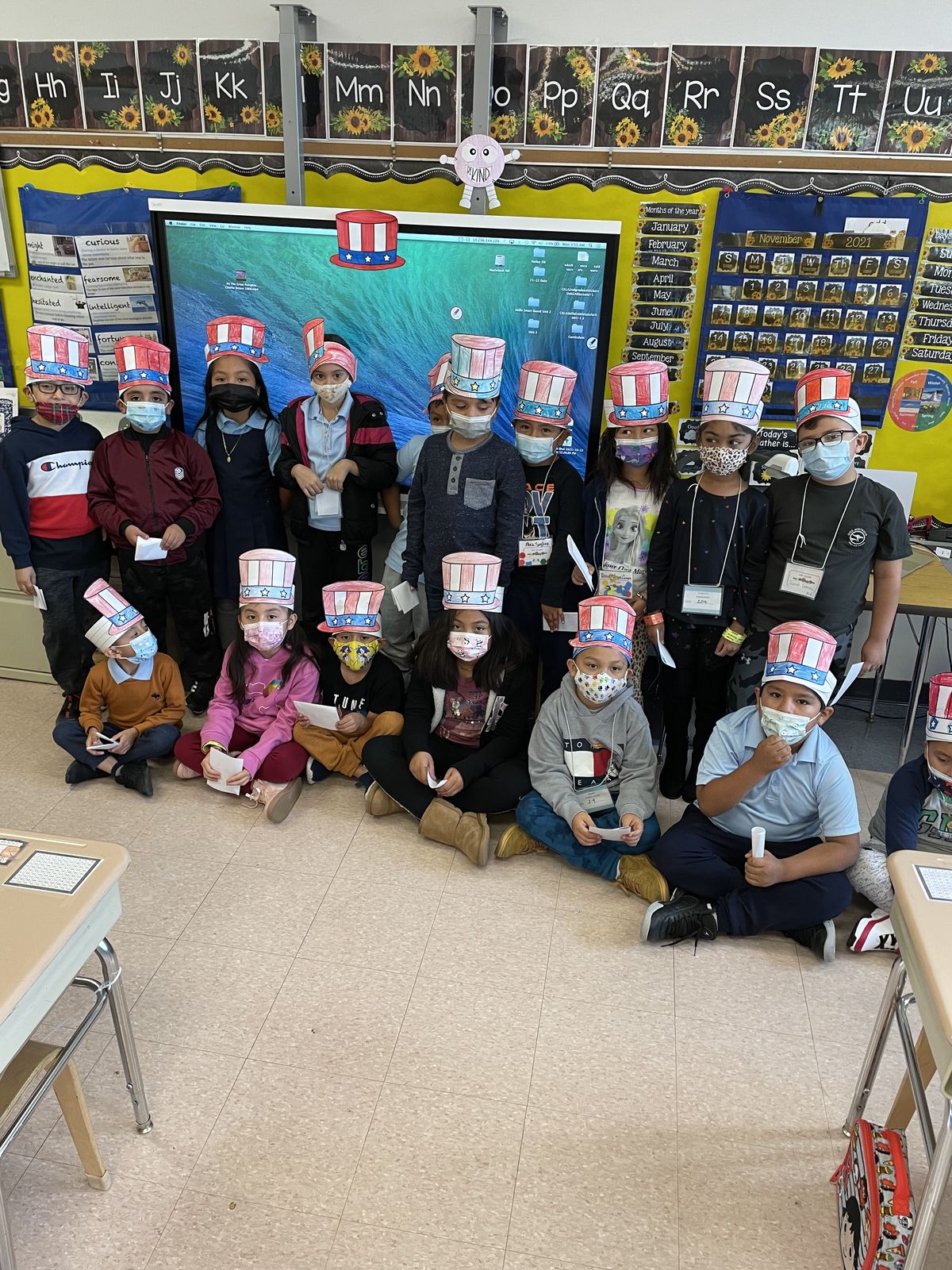Class in paper Uncle Sam hats posing for a photo