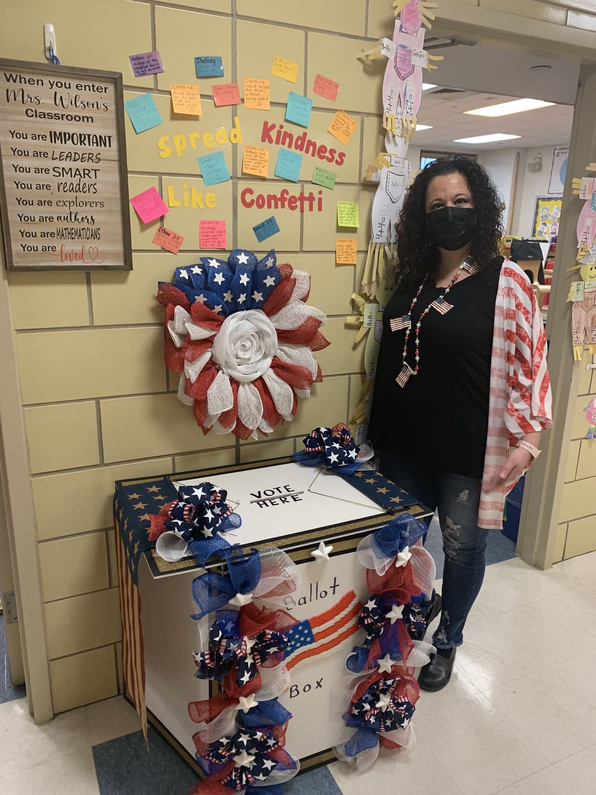 Staff member standing beside the decorated ballot box