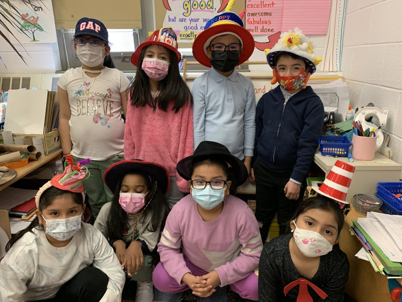 Students in colorful hats posing for a class photo