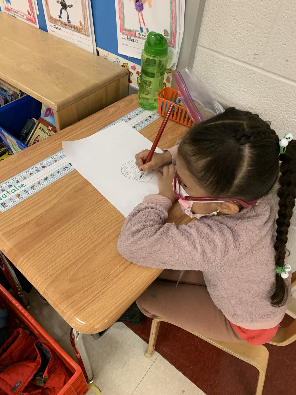 Student drawing at her desk