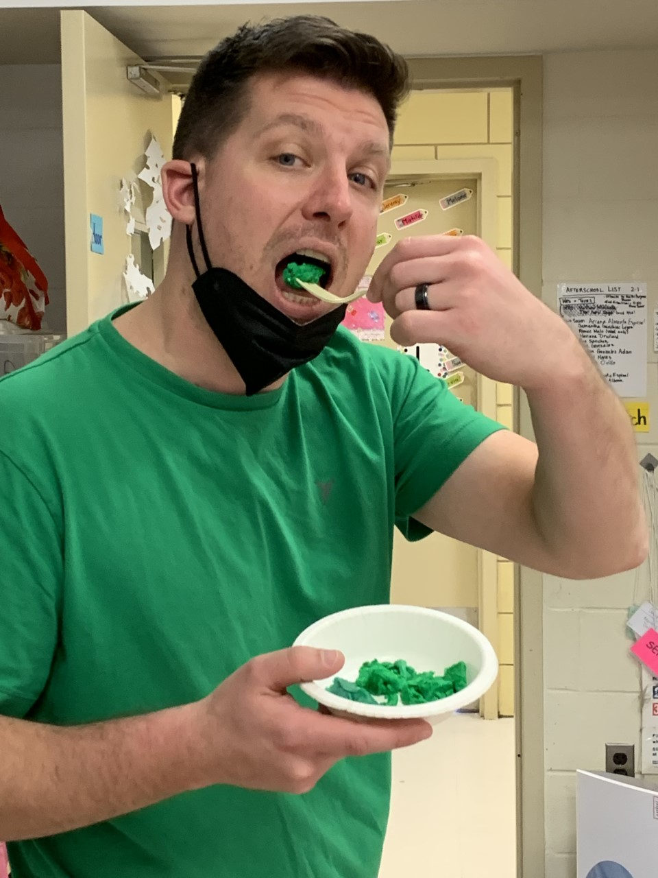 Teacher in a green shirt tasting green eggs