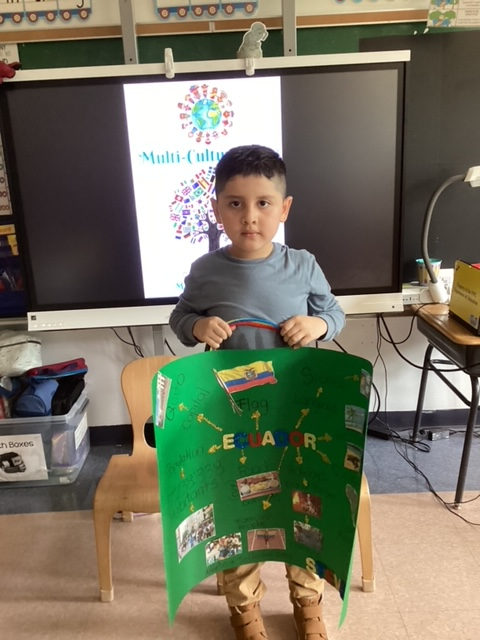 Student holding a green trifold country project