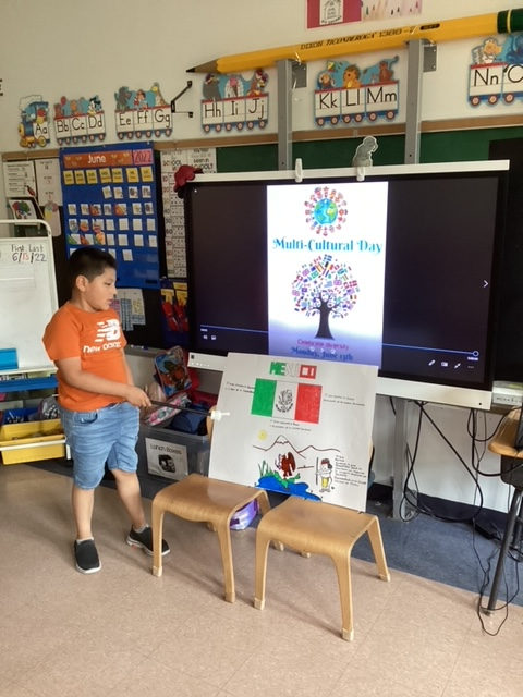 Student presenting a Mexico poster on Multicultural Day