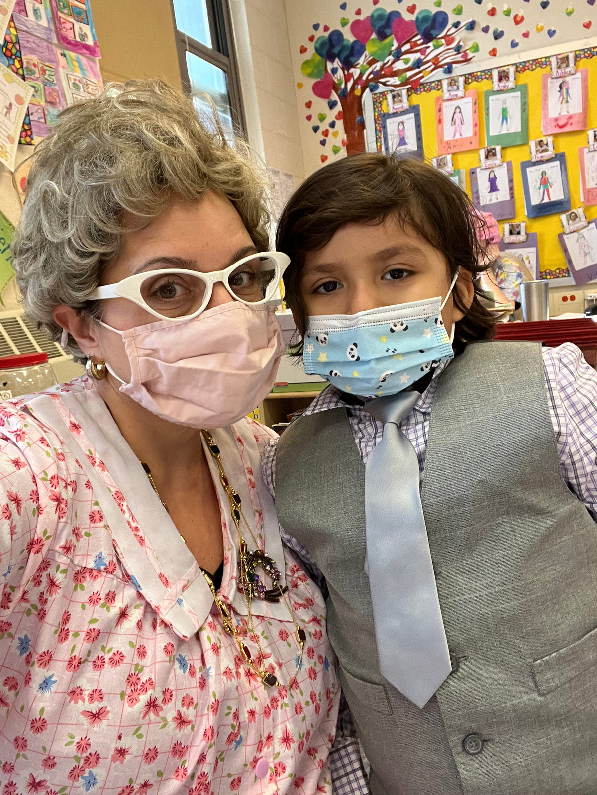 Teacher dressed as a grandmother posing with a student dressed as an old man