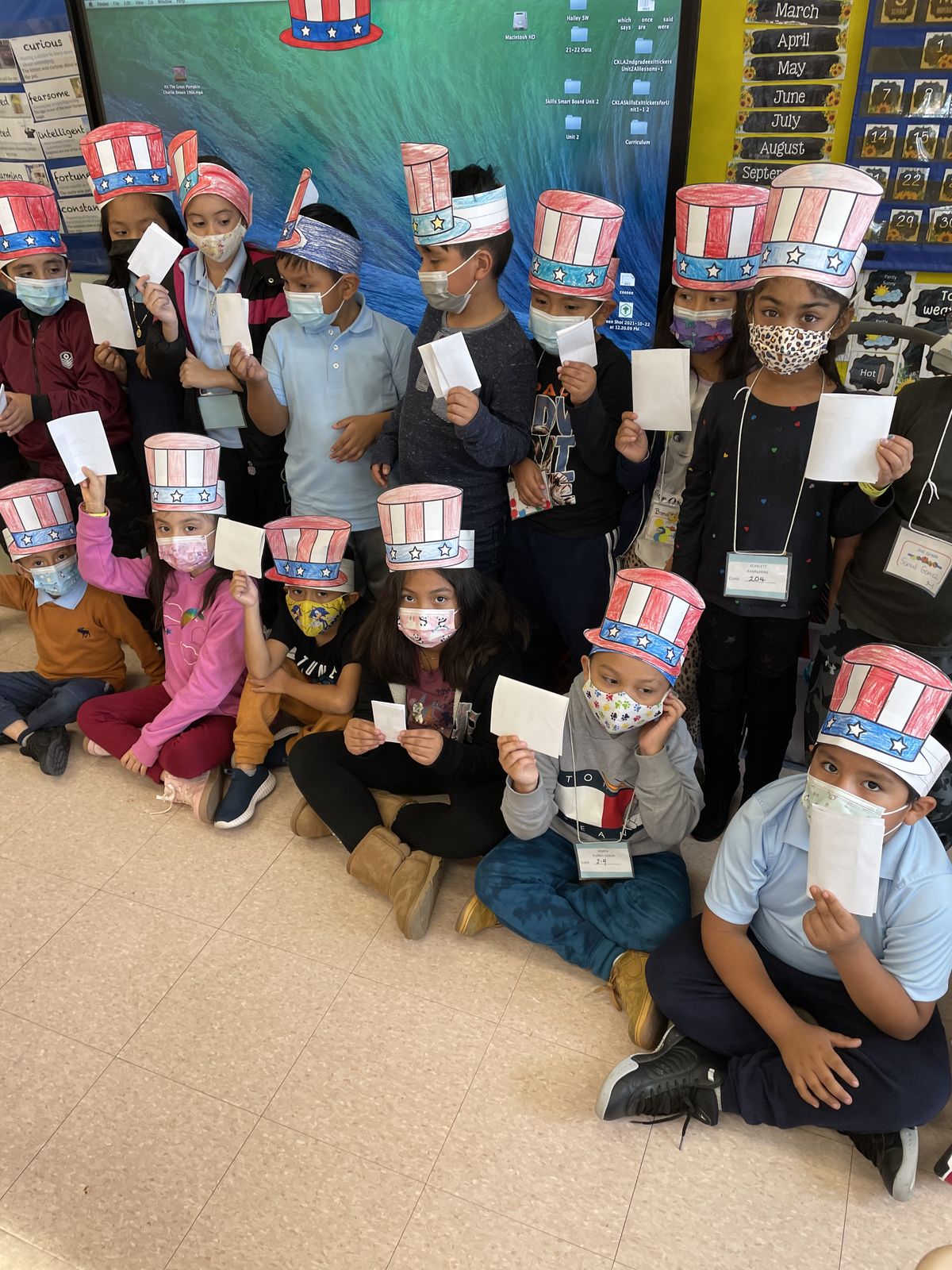Class in paper Uncle Sam hats holding up their ballots