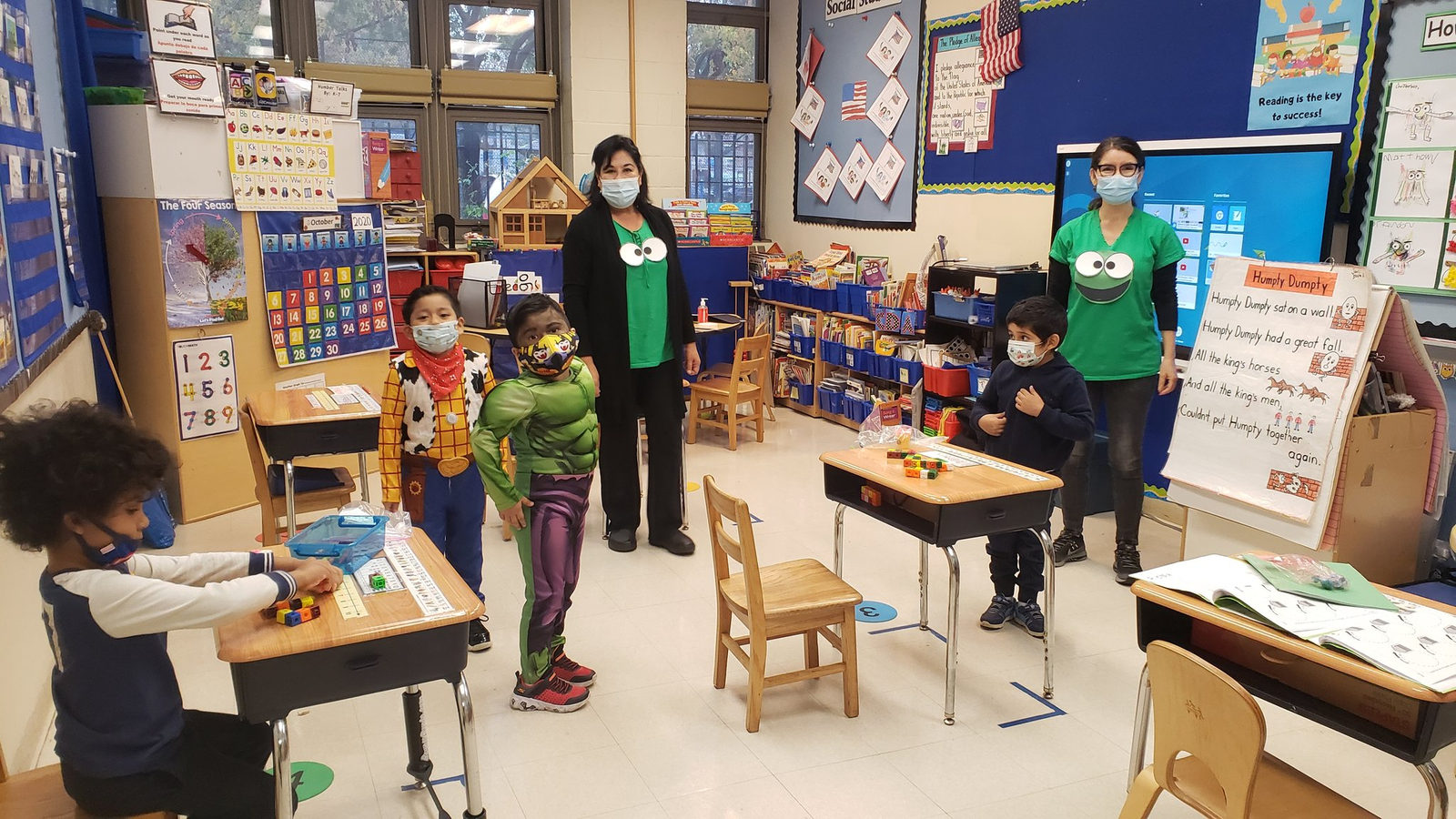 Class in Halloween costumes with their teachers