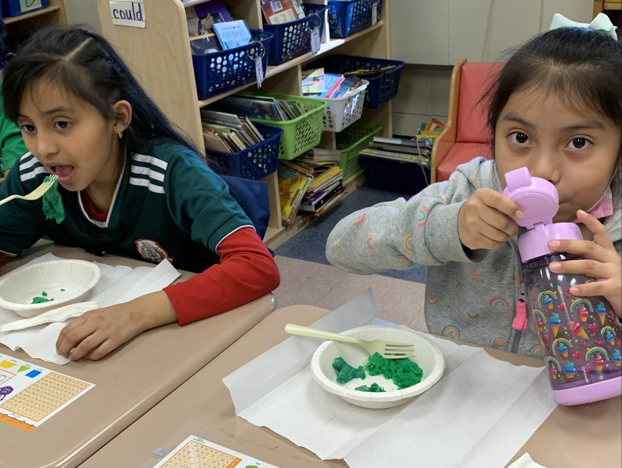 Students tasting green eggs, one drinking from a water bottle
