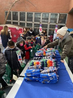 Students picking out gifts at an outdoor table