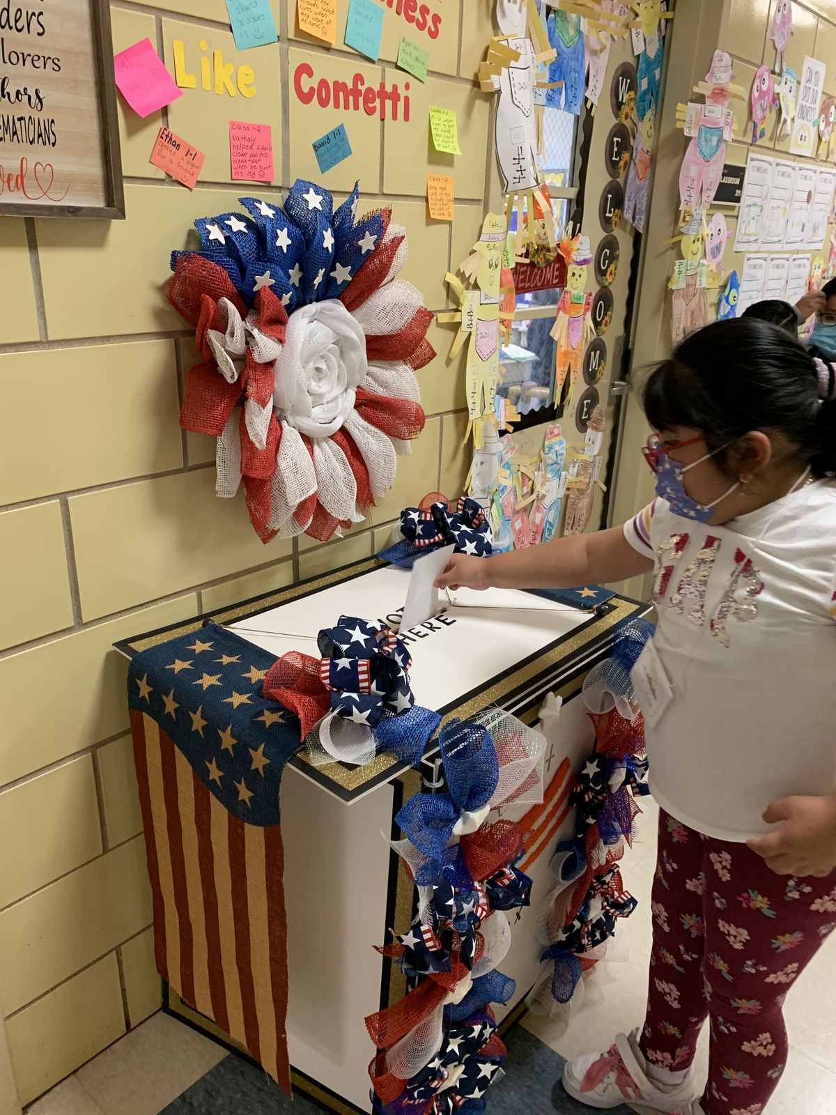 Student voting at the ballot box in the hallway