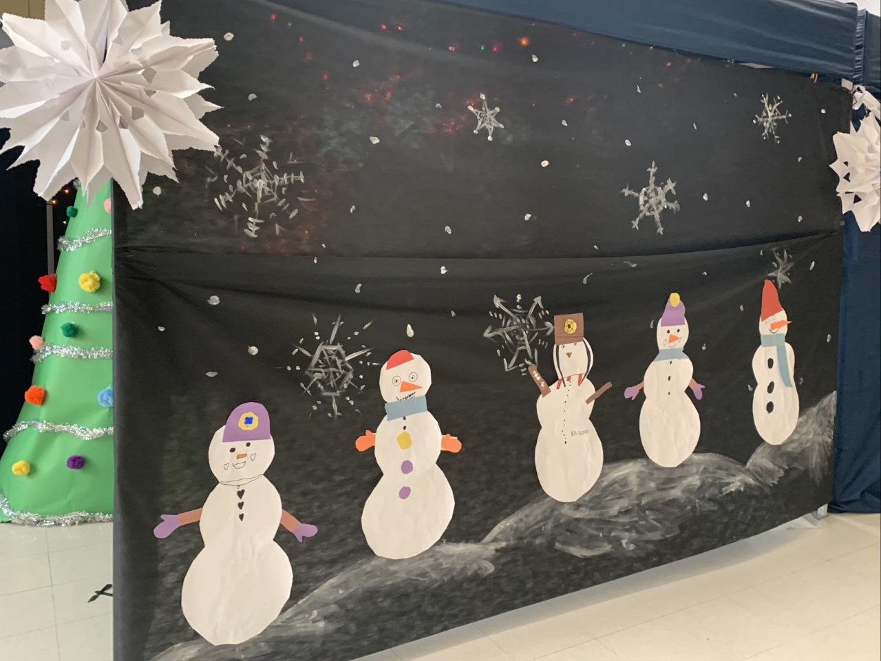 Snowman cutouts decorating a winter backdrop