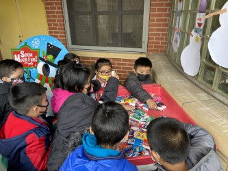 Students choosing items from a holiday table