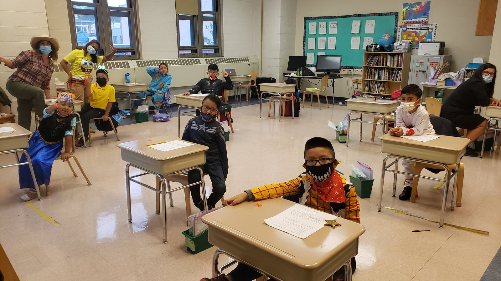 Student in a costume at his desk in a Halloween classroom