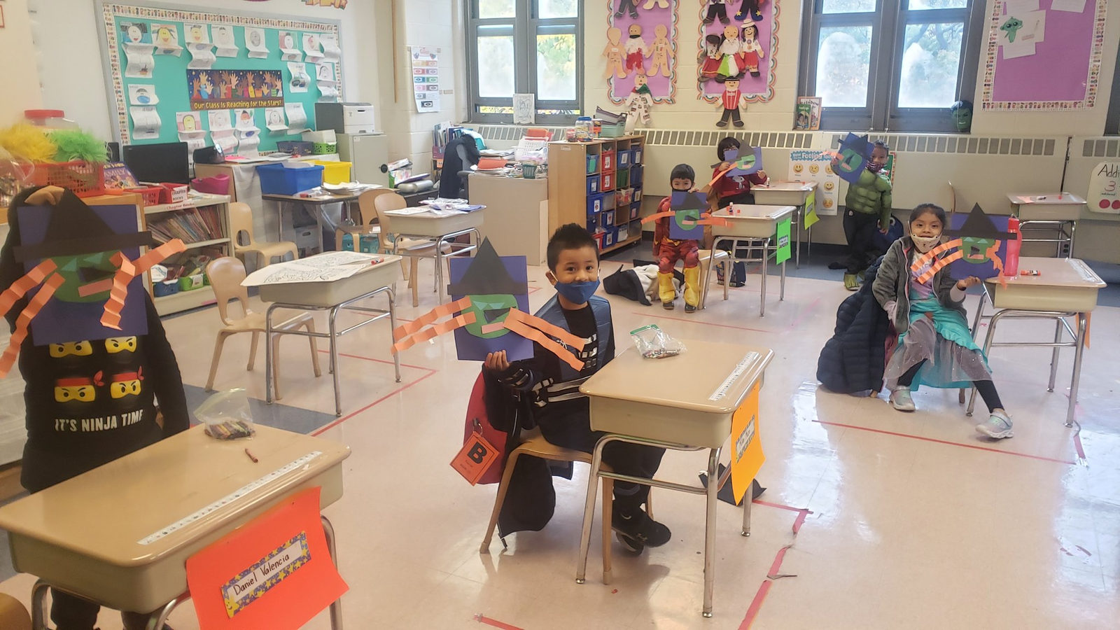 Students in Halloween costumes at their desks