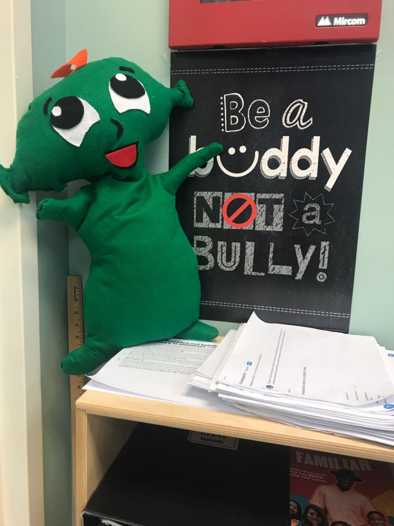 Z the green character beside a Be a Buddy Not a Bully sign