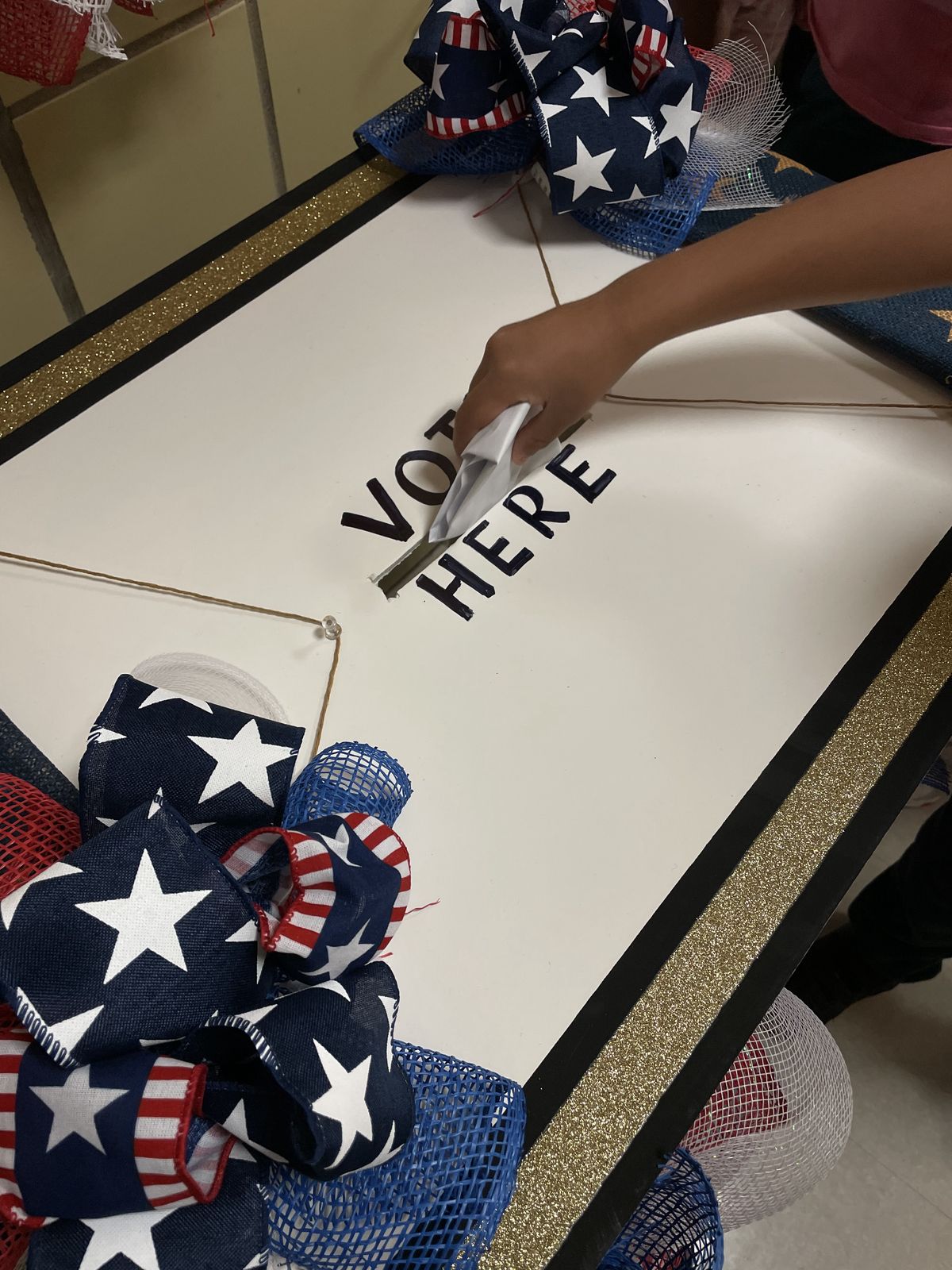 Close-up of a ballot going into the Vote Here box