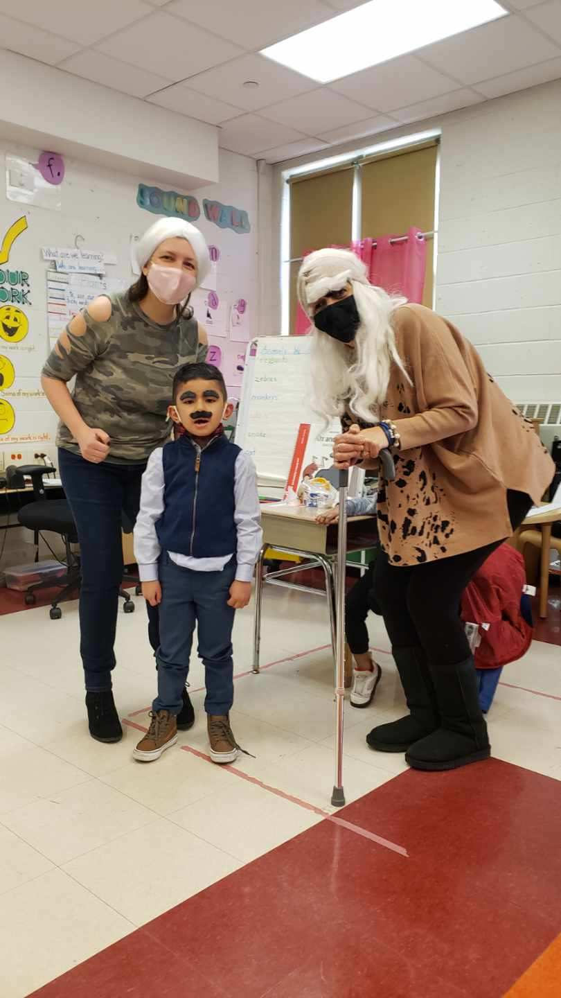 Staff members dressed as grandparents with a student