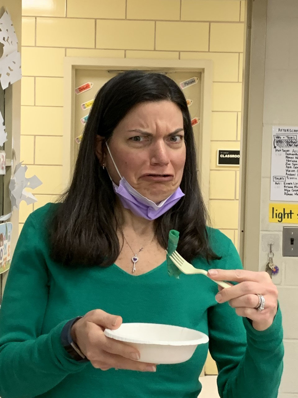 Teacher making a face while tasting green eggs