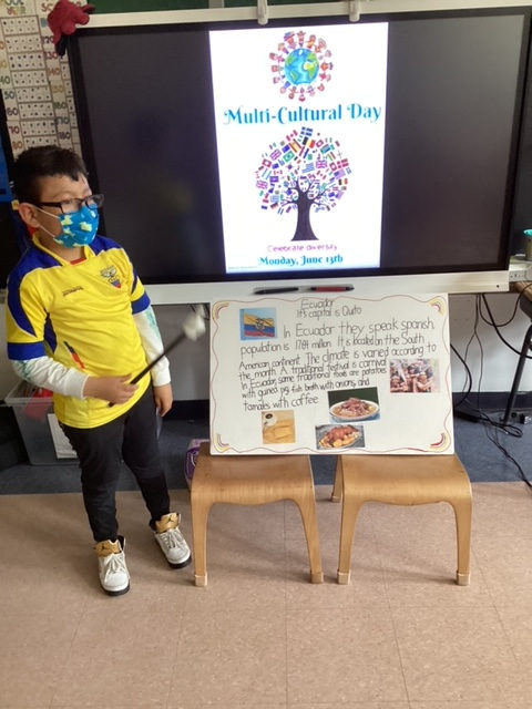 Student in a yellow jersey presenting a poster about food