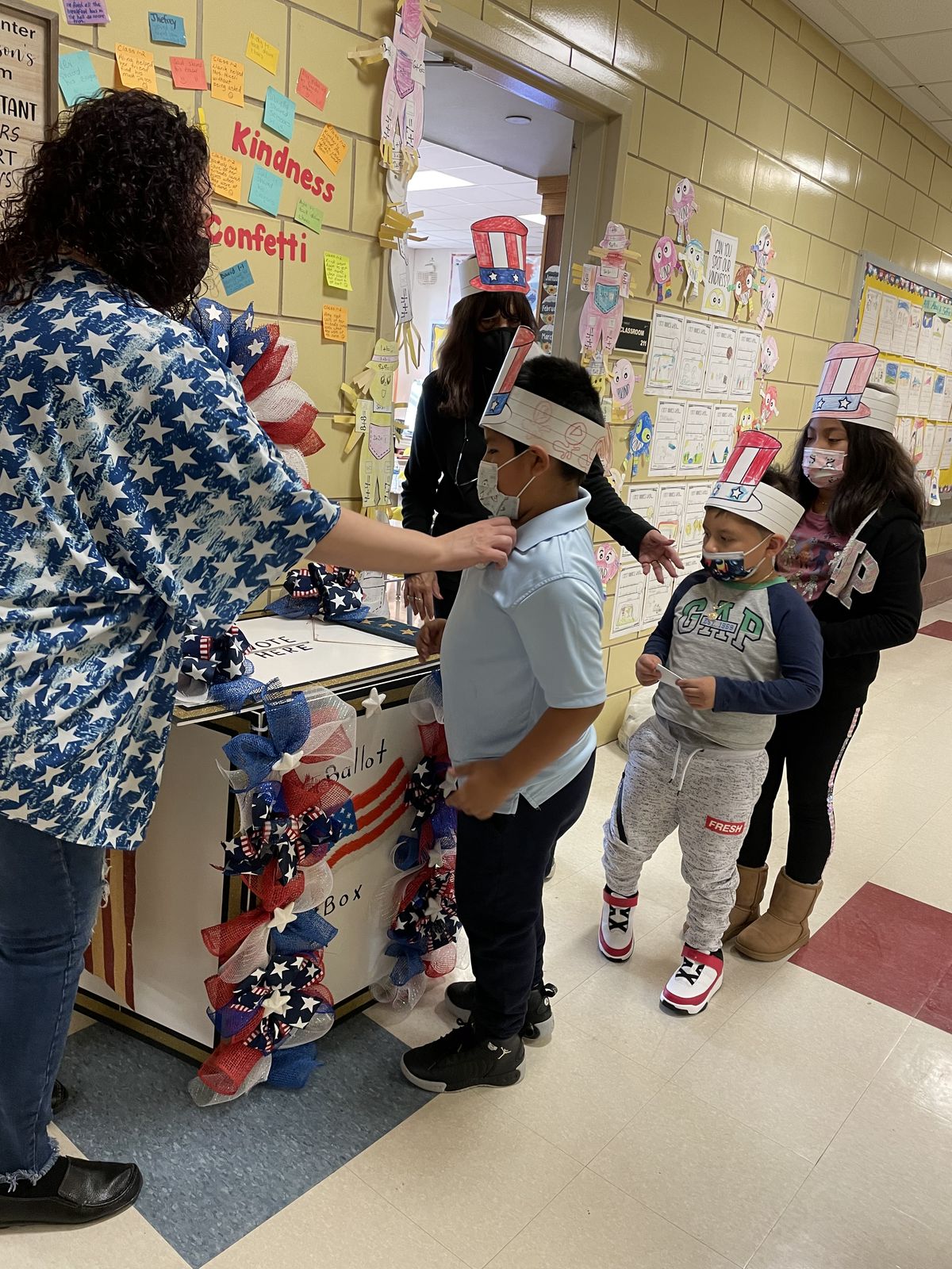 Students lining up to vote at the decorated ballot box