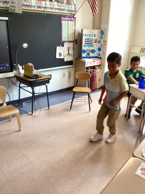 Student walking up to present at the front of the classroom