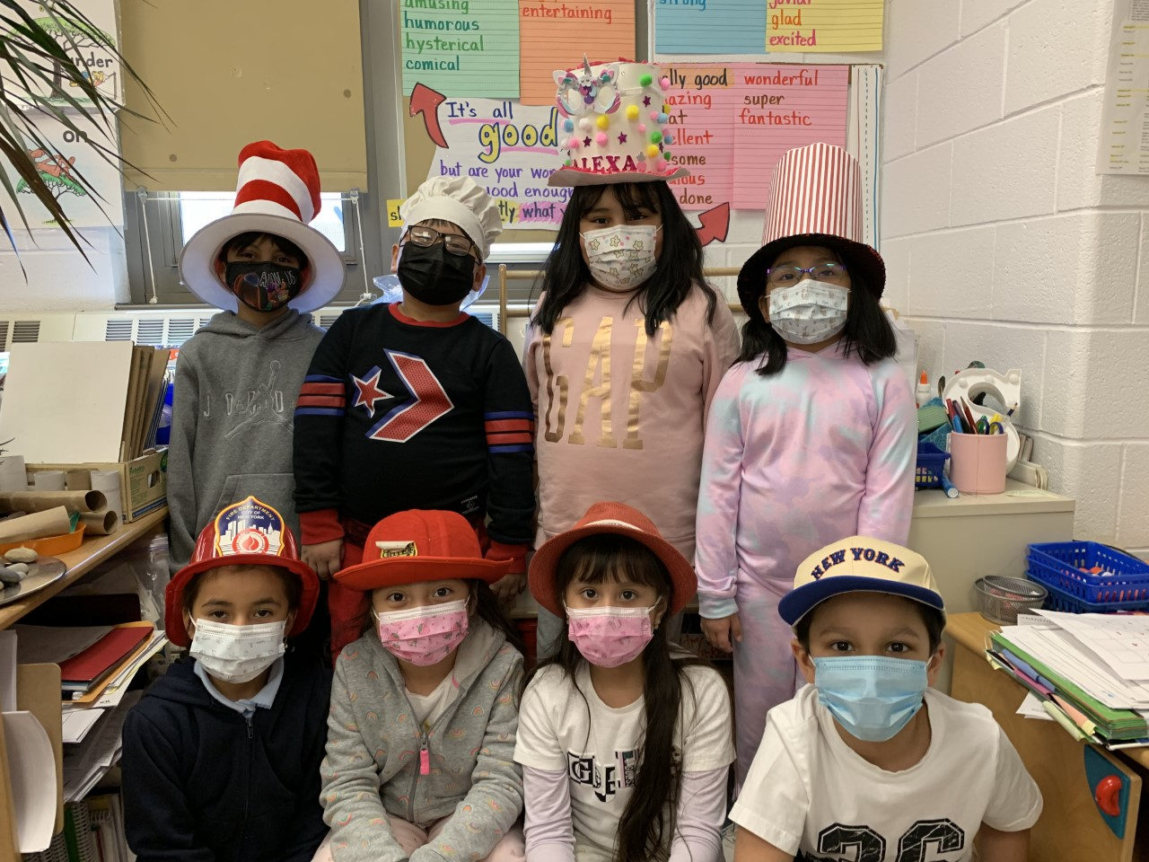 Students in Cat in the Hat and other hats posing for a class photo