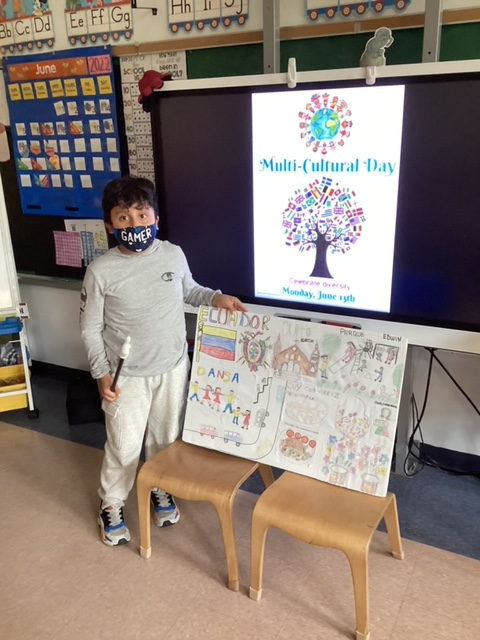 Student in a mask beside a hand-drawn country poster