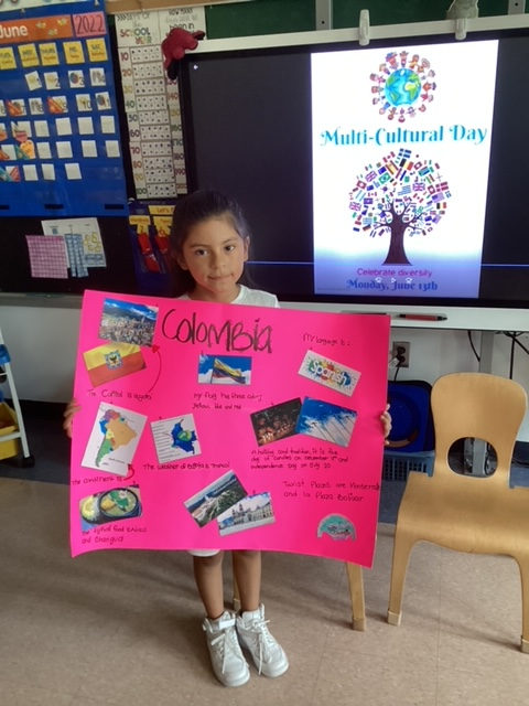 Student holding a pink Colombia poster
