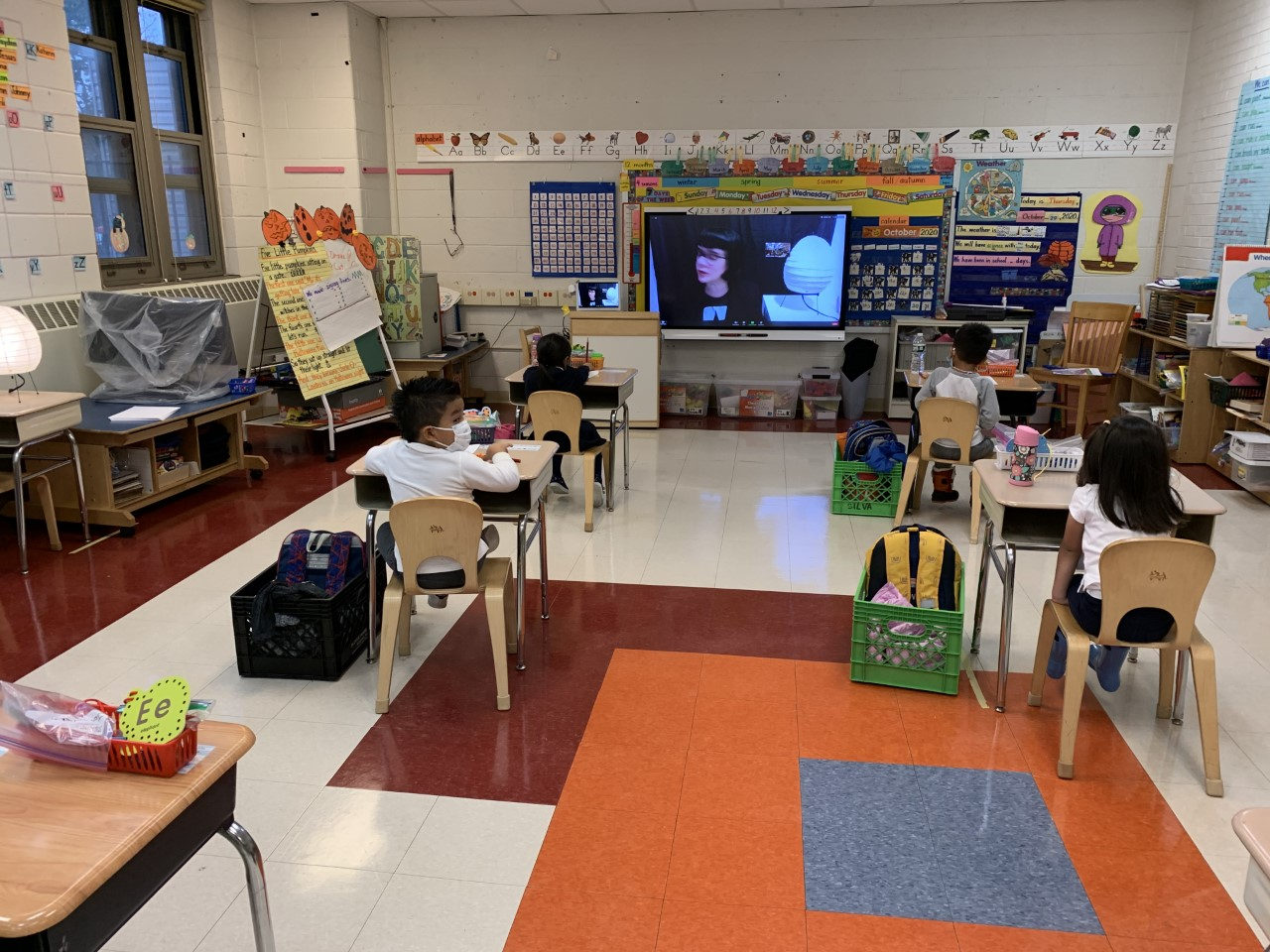 Classroom with students seated at spaced-out desks