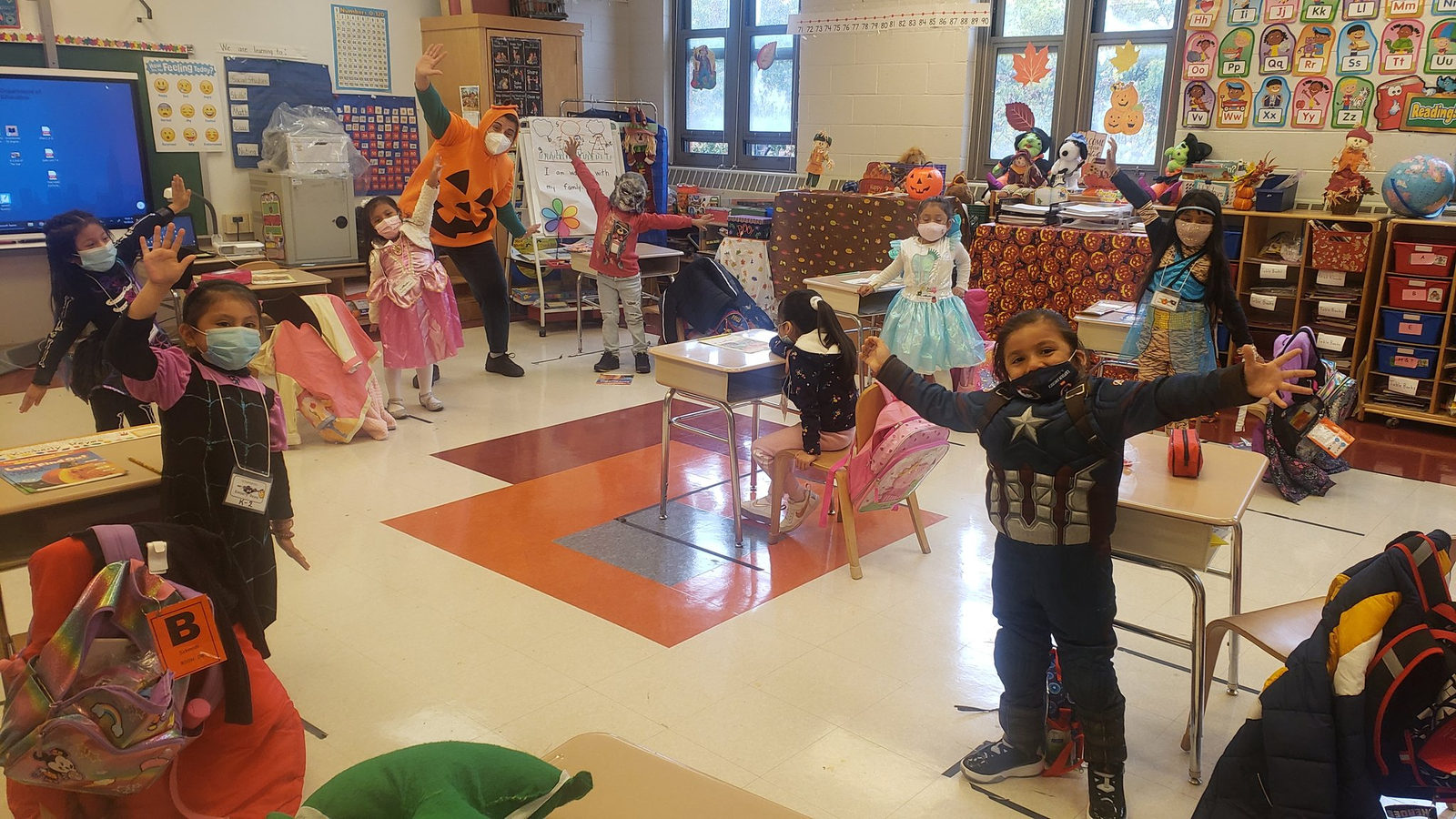 Students in Halloween costumes at their classroom desks