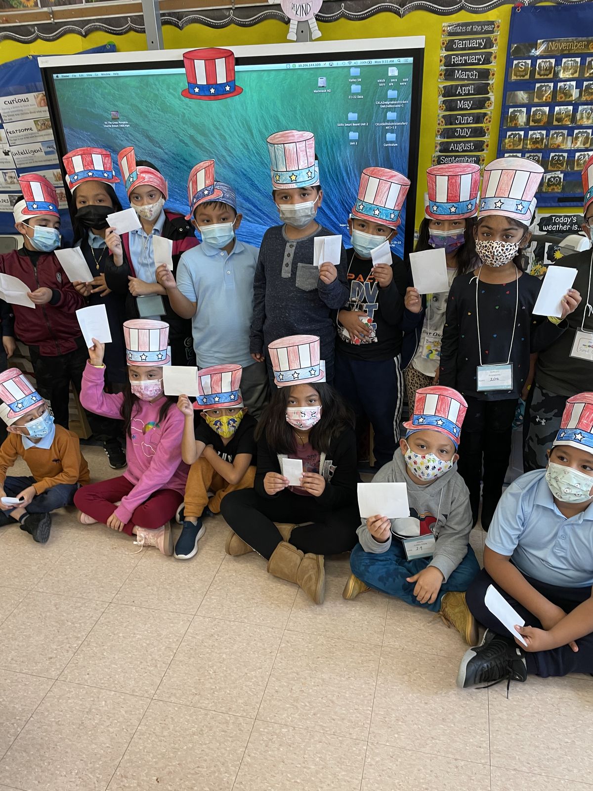Class posing in Uncle Sam hats after voting