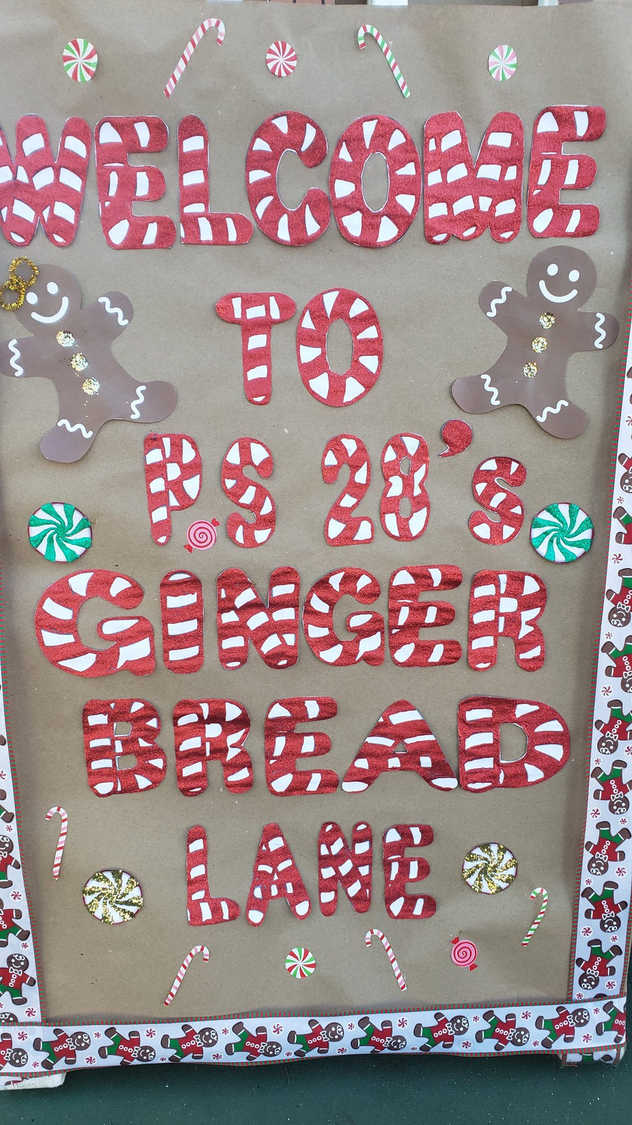Welcome to PS 28's Gingerbread Lane sign decorated with candy canes