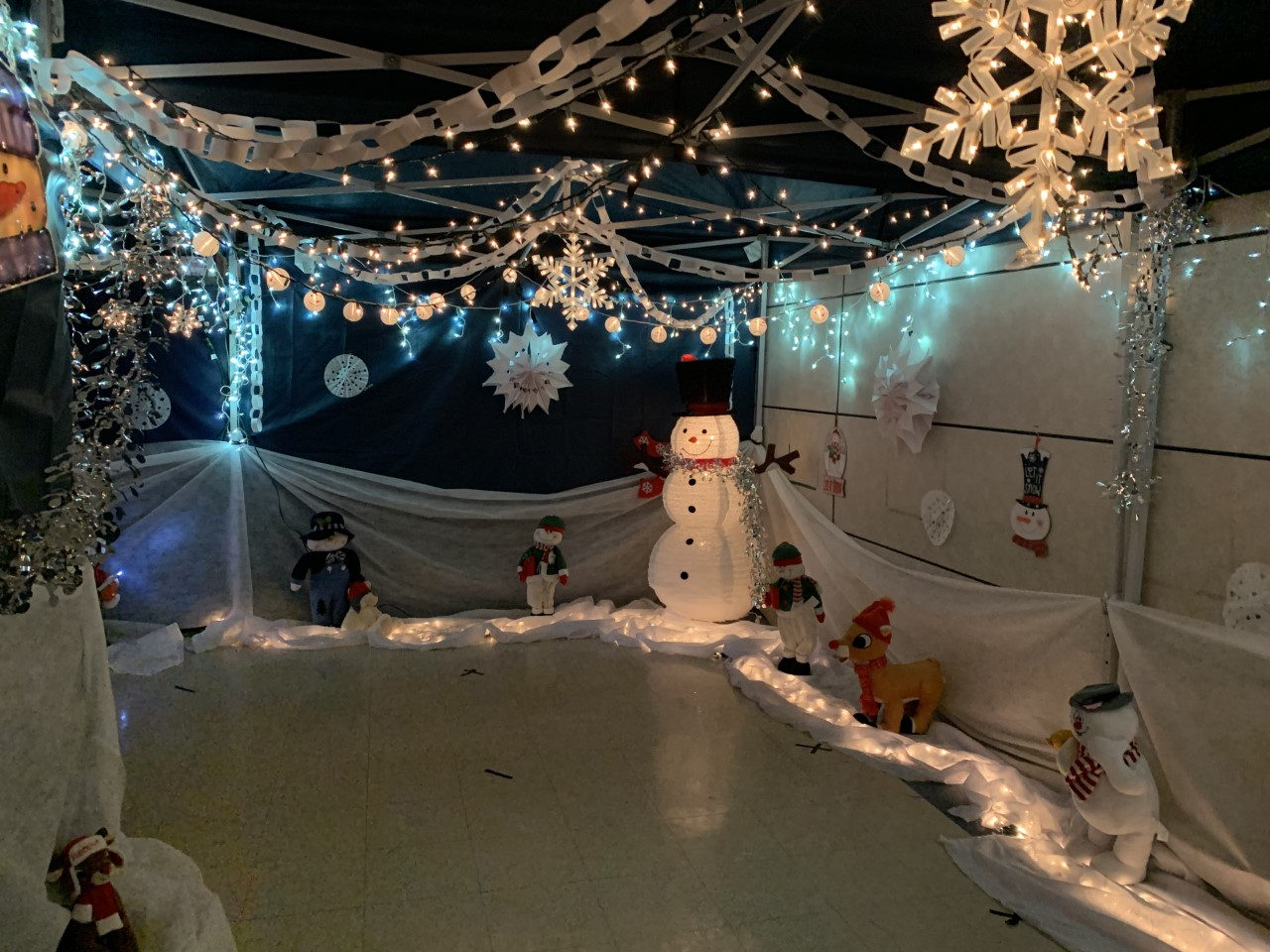 Winter wonderland tent with a snowman and lights