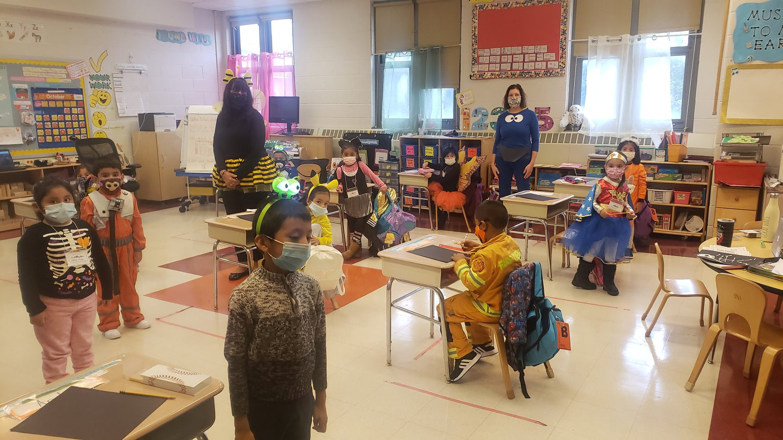 First grade students in Halloween costumes in their classroom