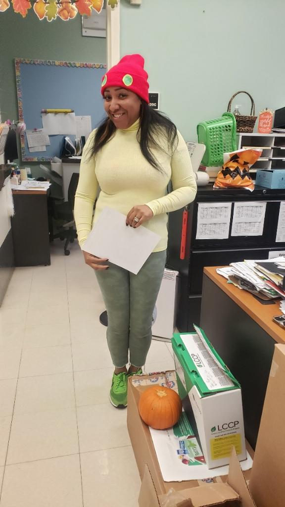 Teacher in a red hat dressed up for Halloween in her classroom