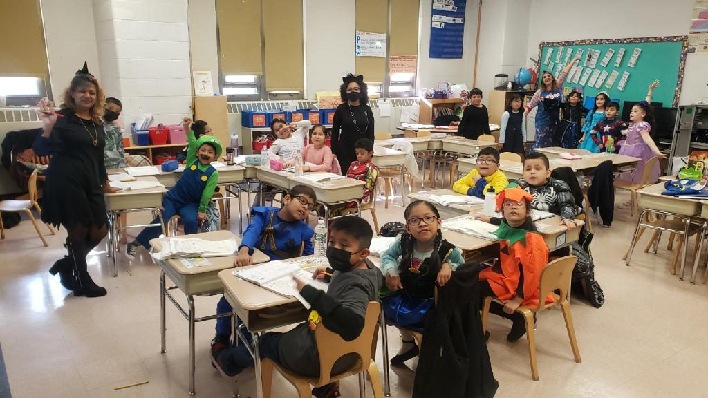 Class in Halloween costumes with their teacher