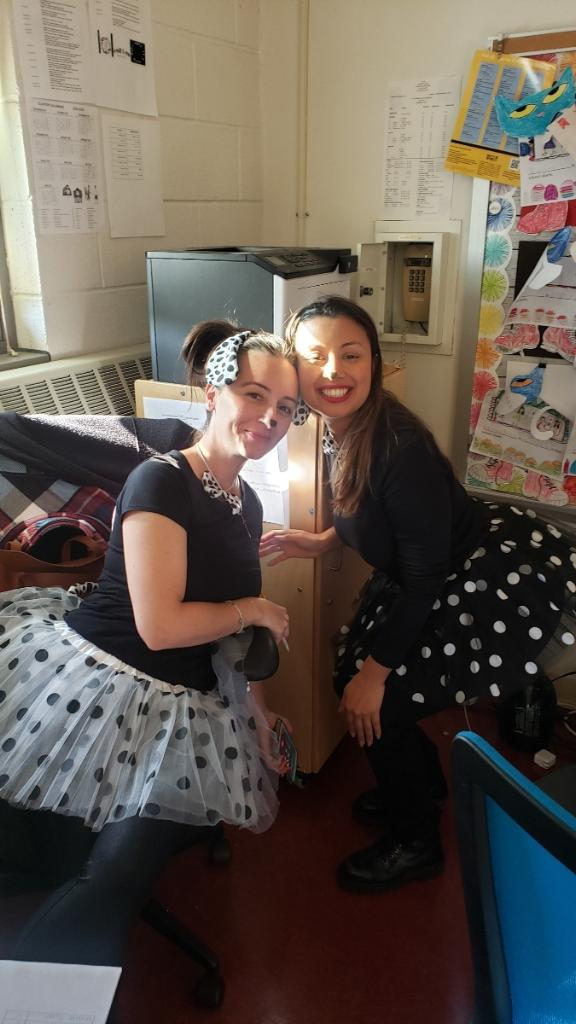 Two teachers in Halloween costumes posing together