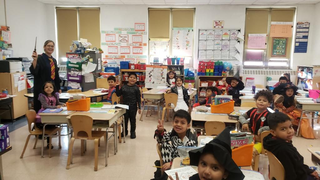 Students in Halloween costumes at their tables
