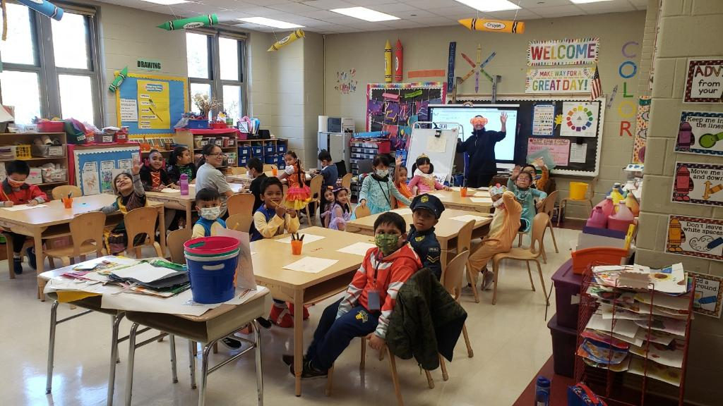 Class in Halloween costumes at their tables