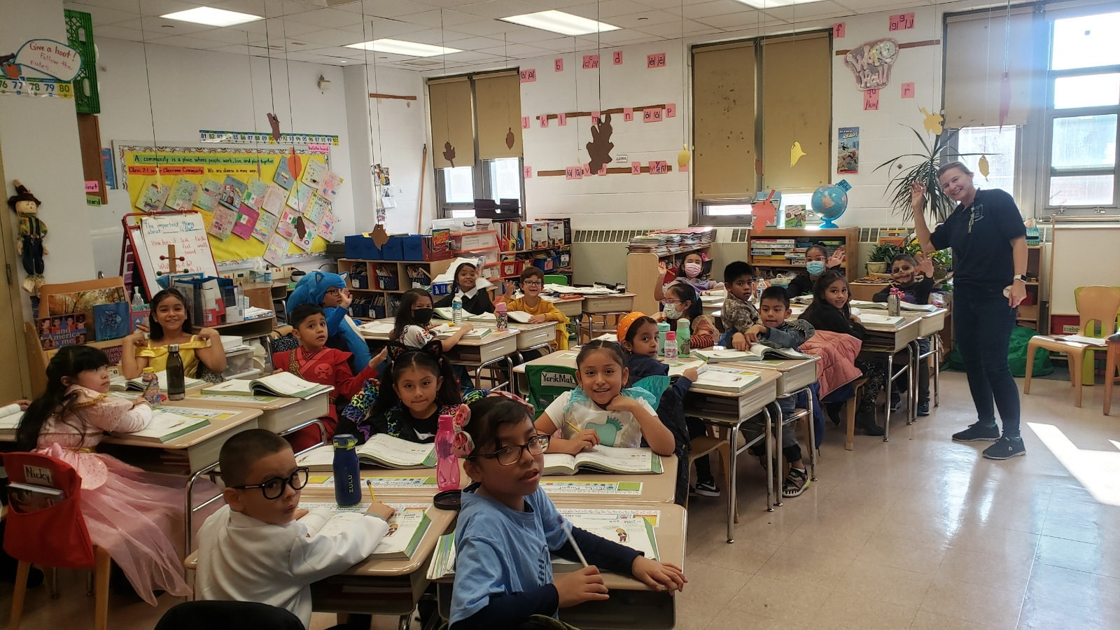 Class in Halloween costumes at their desks
