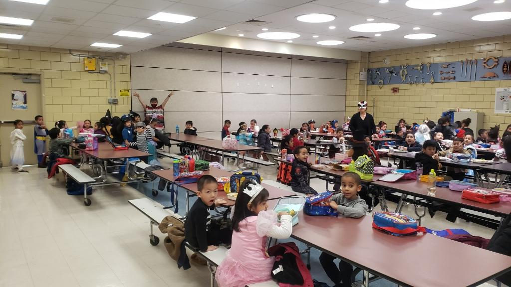 Students in Halloween costumes at the cafeteria tables