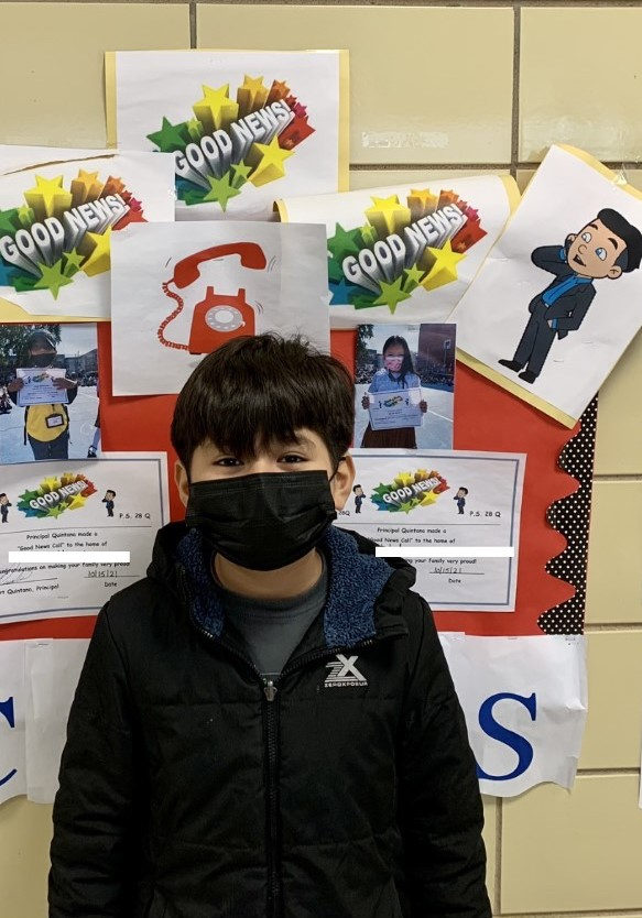 Brian stands in front of the Good News Call bulletin board