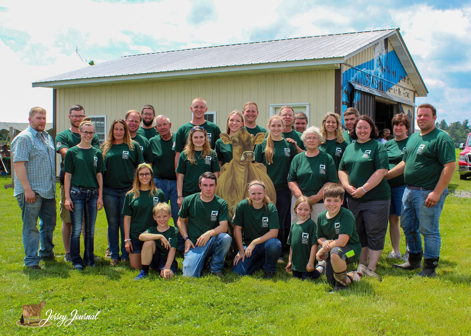The Chittenden family of Dutch Hollow Farm in matching green shirts in front of their farm