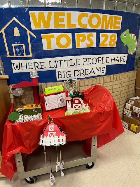A Welcome to PS 28 banner above a barn-themed Charlotte's Web display