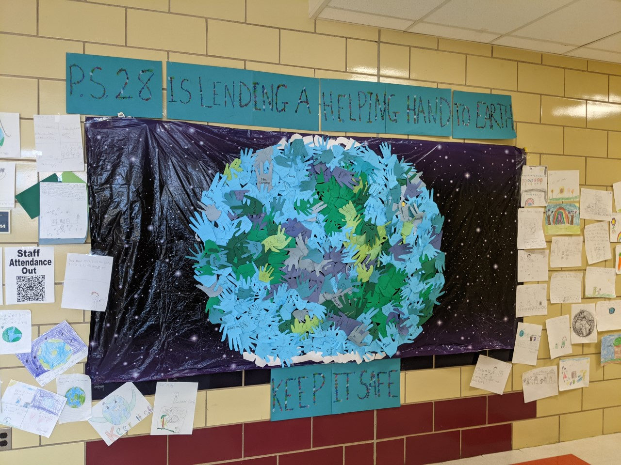 Keep It Safe hand-print Earth bulletin board with student writing