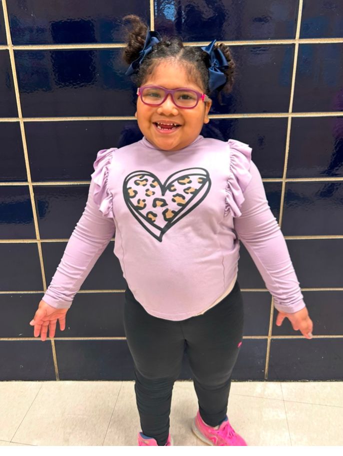 Student ambassador in a lavender sweater with a heart